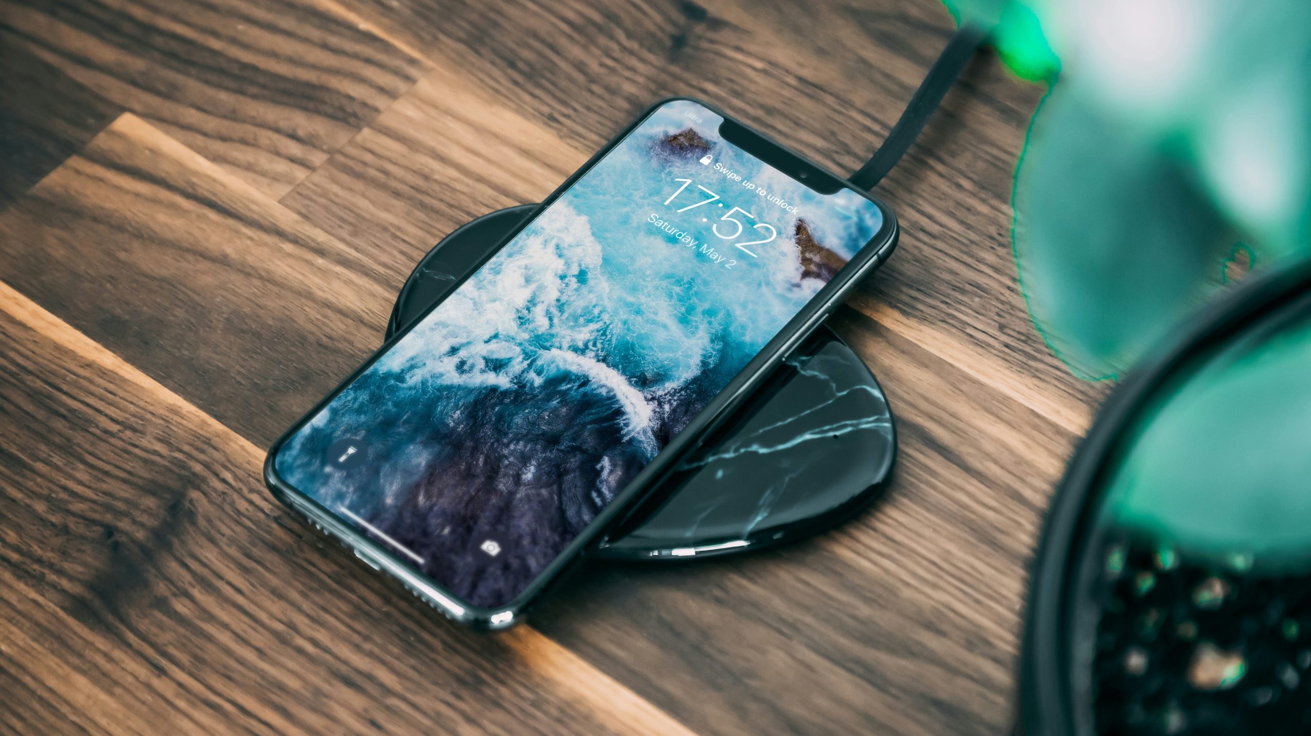 A smartphone charging wirelessly on a charging pad